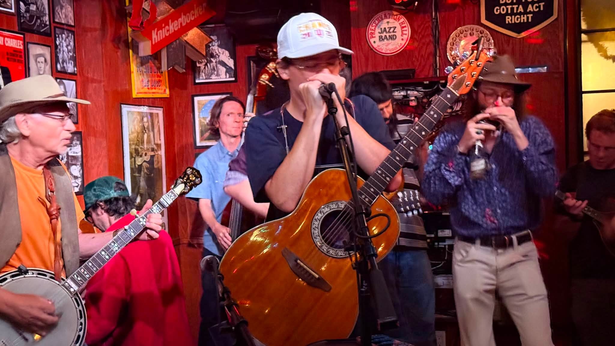 Andrew playing harmonica during a crowded live performance